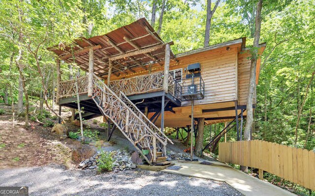 rear view of house featuring a carport