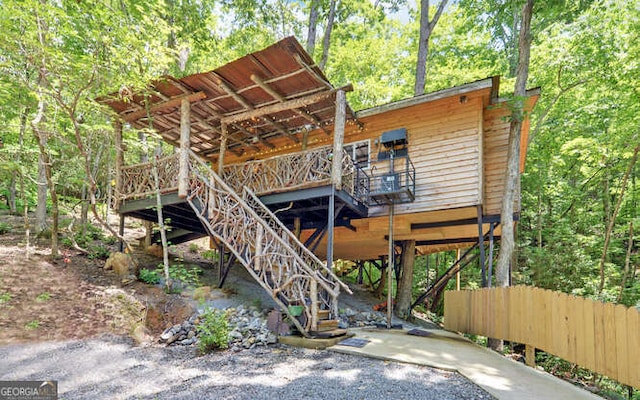 rear view of house featuring a wooden deck