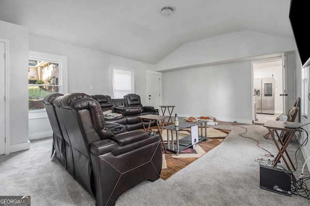 carpeted living room featuring lofted ceiling and plenty of natural light