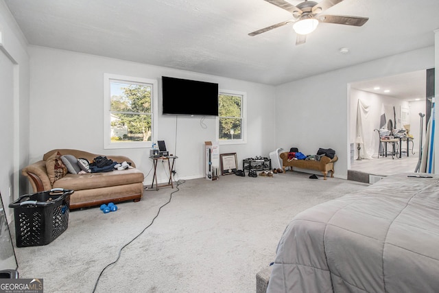 bedroom with ceiling fan and light carpet