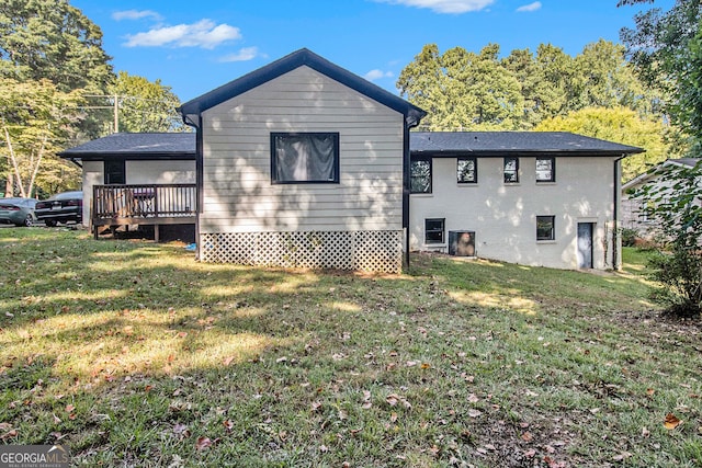 back of property featuring a yard, cooling unit, and a deck