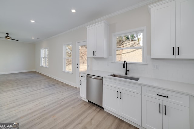 kitchen featuring white cabinetry, a healthy amount of sunlight, stainless steel dishwasher, and sink