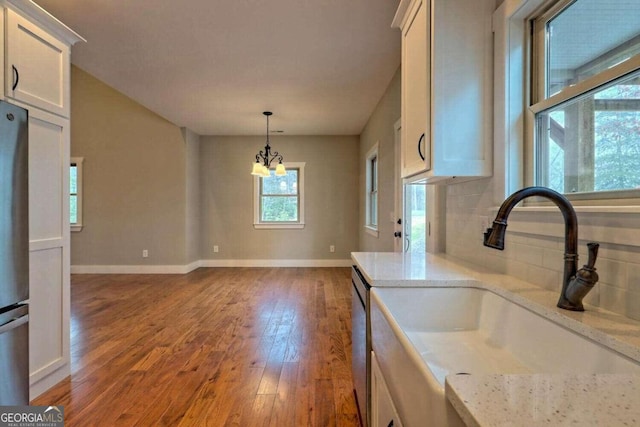 465 Wildflower Rdg, Warne, NC 28909 - kitchen with a sink, pendant lighting, a chandelier, wood finished floors, and white cabinets