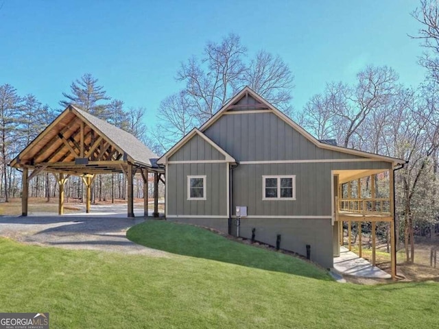465 Wildflower Rdg, Warne, NC 28909 - view of home's exterior with driveway, a detached carport, board and batten siding, and a yard