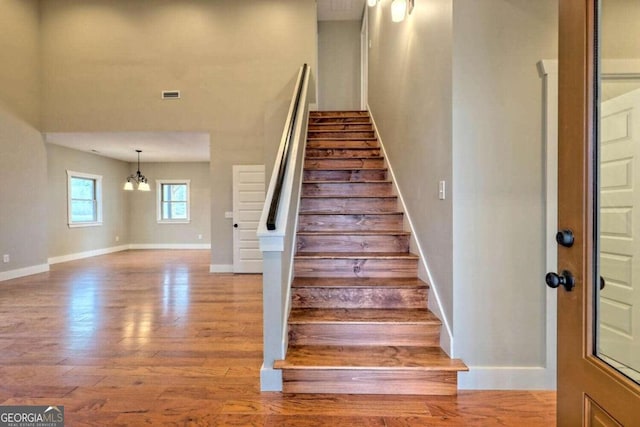 465 Wildflower Rdg, Warne, NC 28909 - stairway featuring baseboards, visible vents, a notable chandelier, and wood finished floors