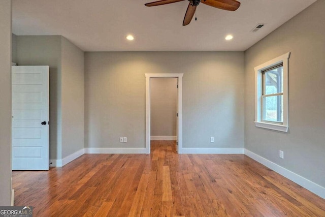 unfurnished room with ceiling fan and hardwood / wood-style floors