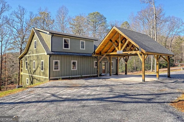 465 Wildflower Rdg, Warne, NC 28909 - view of front facade featuring driveway, a shingled roof, a detached carport, and board and batten siding