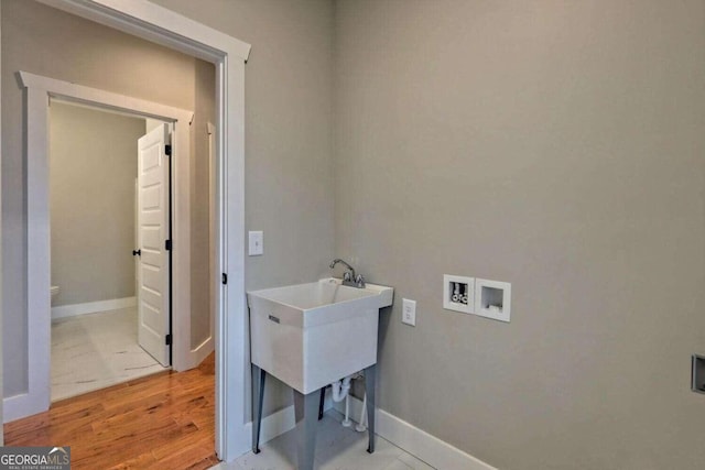 laundry room with hookup for a washing machine and light wood-type flooring