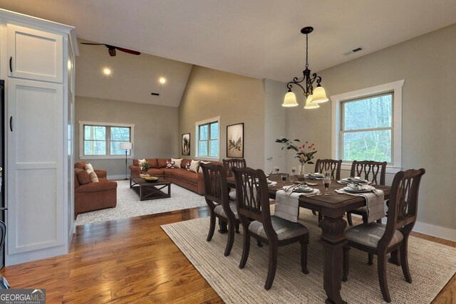 465 Wildflower Rdg, Warne, NC 28909 - dining area with vaulted ceiling, visible vents, wood finished floors, and a healthy amount of sunlight
