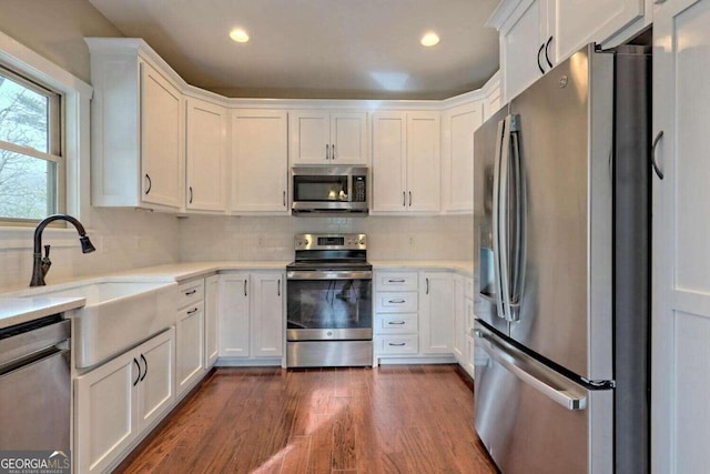 kitchen featuring white cabinets, dark hardwood / wood-style floors, and stainless steel appliances