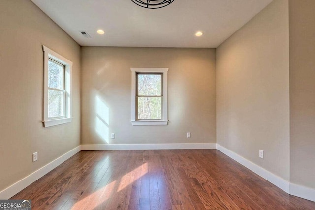 spare room with hardwood / wood-style flooring