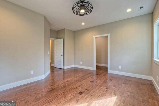 spare room featuring dark hardwood / wood-style flooring