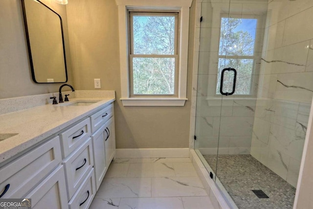 bathroom featuring vanity, an enclosed shower, tile patterned flooring, and a healthy amount of sunlight