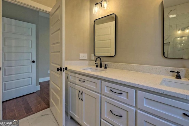 bathroom with wood-type flooring and double sink vanity