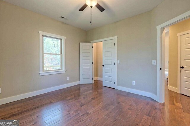 bathroom featuring vanity, toilet, wood-type flooring, and high vaulted ceiling