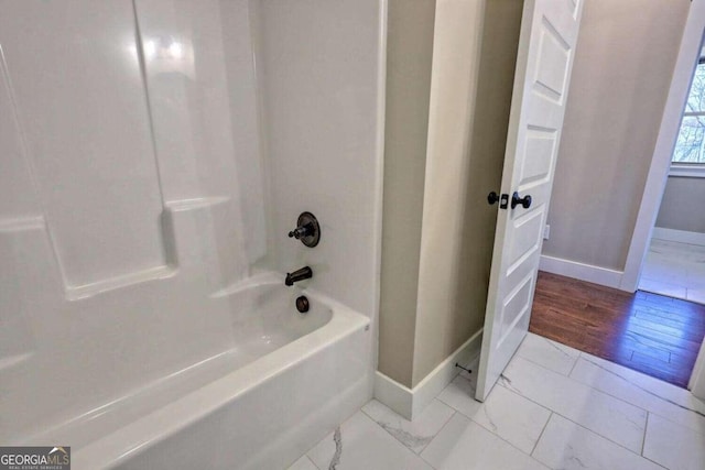 bathroom with shower / bathtub combination and wood-type flooring