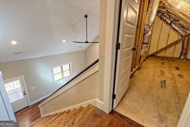 staircase with hardwood / wood-style flooring, lofted ceiling, and a wealth of natural light