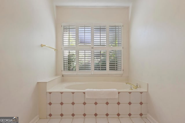 bathroom featuring tile patterned floors and tiled bath