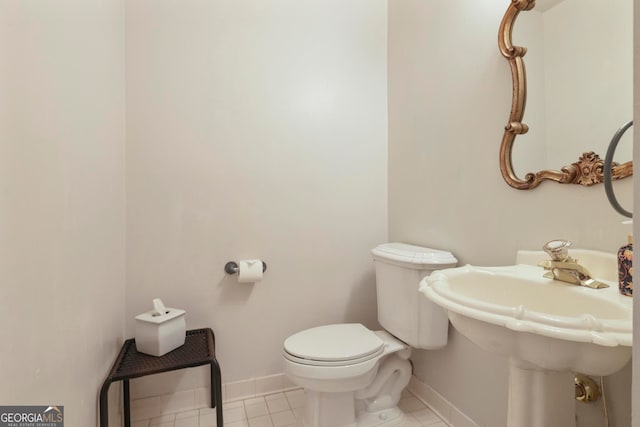 bathroom with toilet and tile patterned flooring