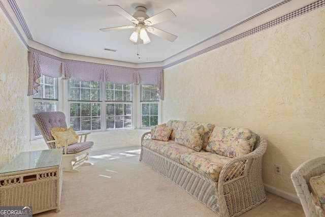 living area with carpet floors and ceiling fan