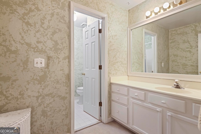 bathroom featuring toilet, vanity, and tile patterned floors