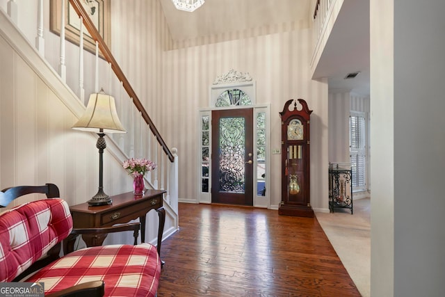 entryway featuring dark wood-type flooring and a high ceiling