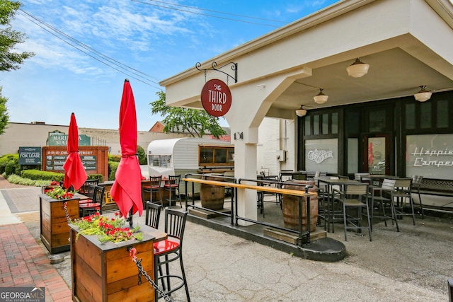 view of patio / terrace featuring an outdoor bar and ceiling fan