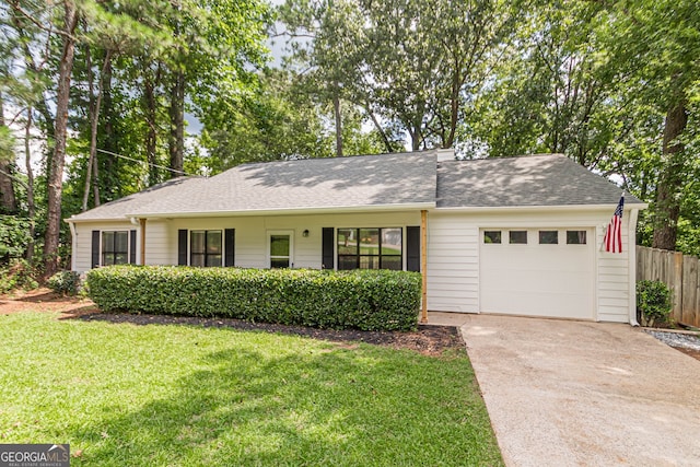 ranch-style home with a garage and a front lawn