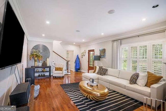 living room featuring crown molding and hardwood / wood-style floors