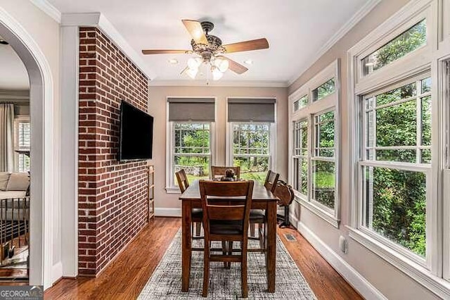 sunroom / solarium with ceiling fan and a healthy amount of sunlight