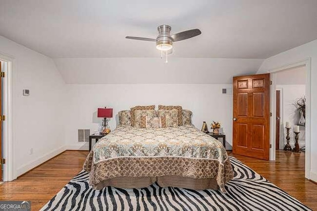 bedroom featuring ceiling fan, wood-type flooring, and lofted ceiling