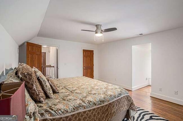 bedroom with light wood-type flooring, ceiling fan, and lofted ceiling