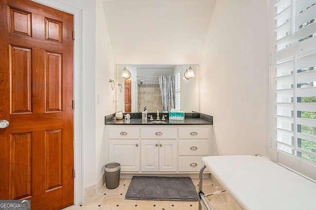 bathroom featuring a washtub and vanity