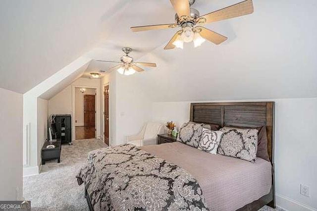 bedroom with ceiling fan, lofted ceiling, and light carpet