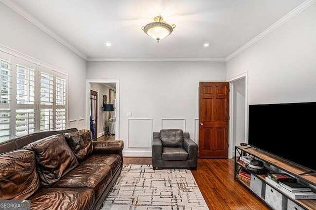 living room with hardwood / wood-style floors and ornamental molding