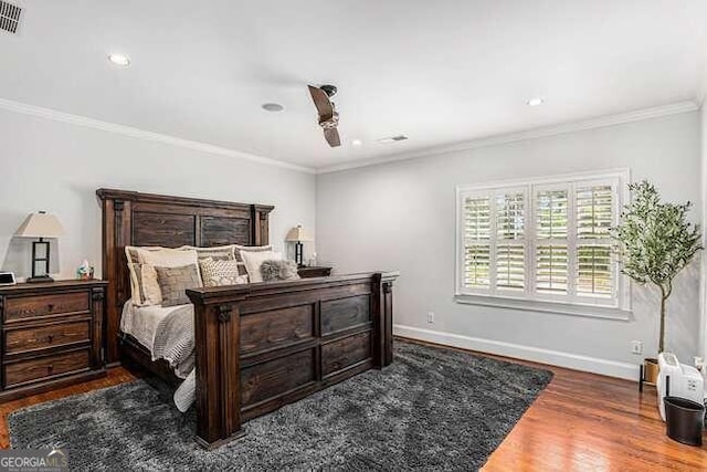 bedroom featuring crown molding and dark wood-type flooring