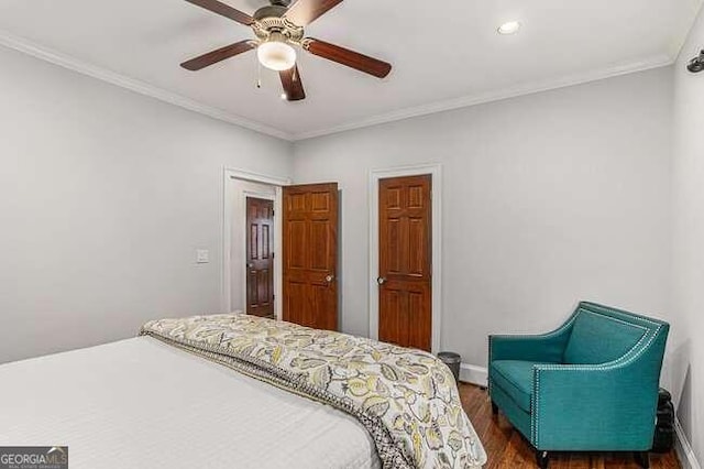 bedroom featuring ceiling fan, dark hardwood / wood-style floors, and ornamental molding