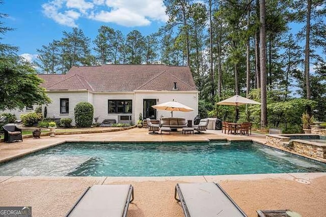 view of pool with a patio area and an outdoor hangout area