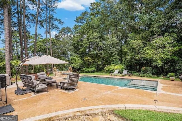 view of pool featuring outdoor lounge area and a patio area