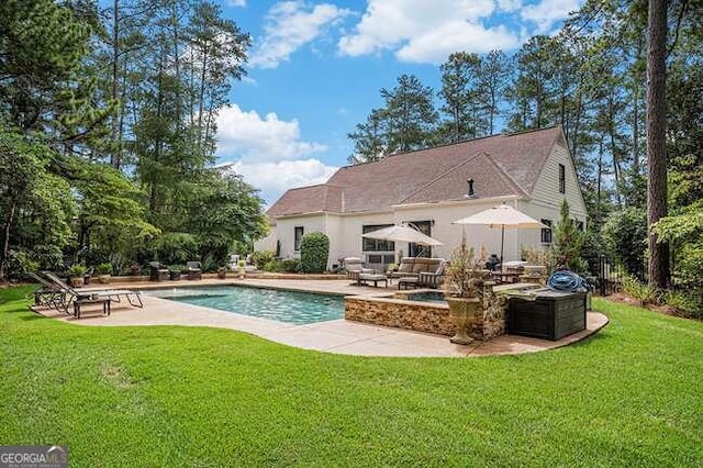 view of pool featuring a lawn and a patio area