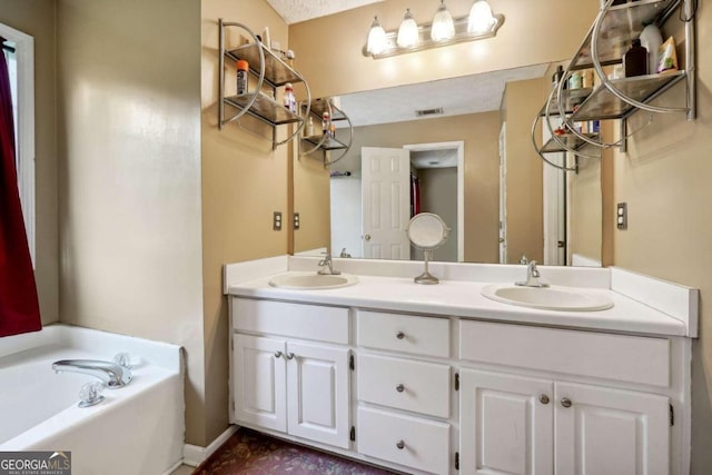 full bath featuring a garden tub, a sink, visible vents, and double vanity