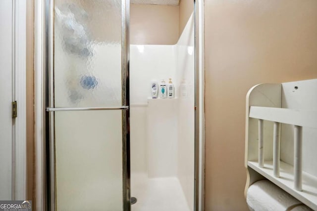 bathroom featuring a shower with shower door