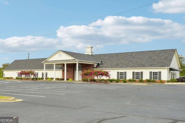 view of building exterior with uncovered parking