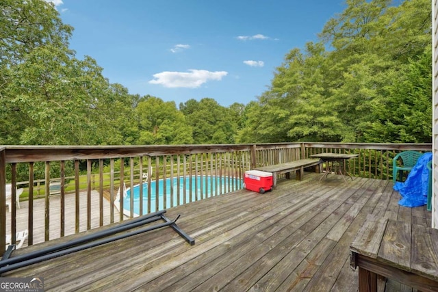 wooden terrace featuring an outdoor pool