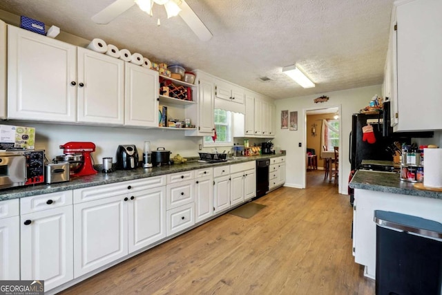 kitchen with black dishwasher, open shelves, dark countertops, and white cabinets