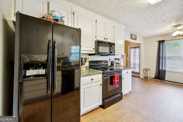 kitchen with light wood finished floors, white cabinets, ceiling fan, a textured ceiling, and black appliances