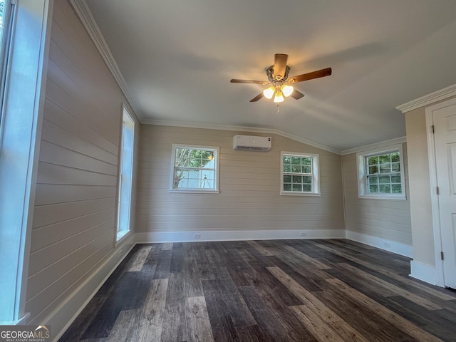 spare room featuring crown molding, plenty of natural light, dark hardwood / wood-style flooring, and an AC wall unit