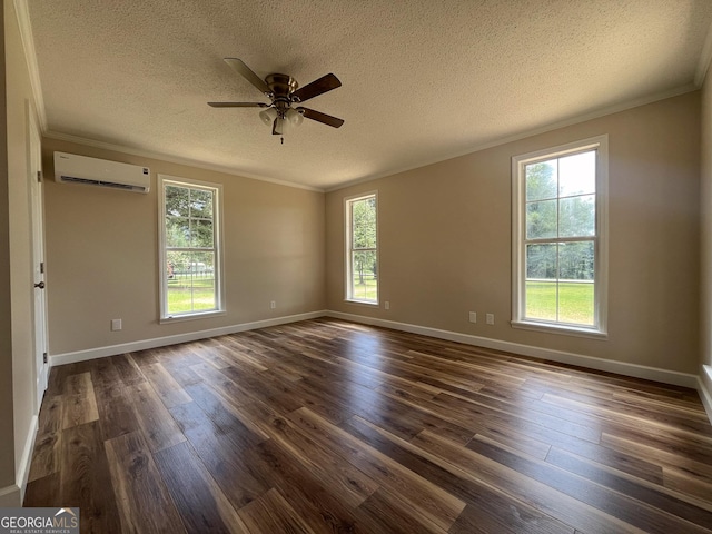 spare room with ornamental molding, an AC wall unit, a textured ceiling, and dark hardwood / wood-style flooring