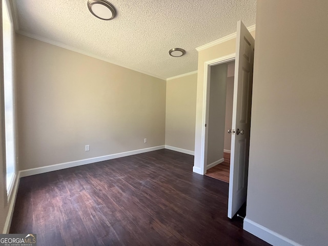 empty room featuring crown molding, dark hardwood / wood-style flooring, and a textured ceiling