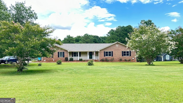 single story home with a front yard and covered porch